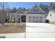 Charming single-story home featuring a three-car garage and an inviting covered front porch at 625 Timberbrook Dr, Sharpsburg, GA 30277