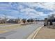 Gated community entrance with stone pillars and black metal gate set against a partly cloudy sky at 625 Timberbrook Dr, Sharpsburg, GA 30277