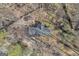 An aerial view shows a secluded residence enveloped by trees and nature, reachable via a driveway at 6198 Rocky Creek Dr, Douglasville, GA 30135