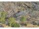 An aerial perspective captures a charming house embraced by a serene, wooded area, accessed via private driveway at 6198 Rocky Creek Dr, Douglasville, GA 30135