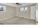 Bright bedroom with two windows and neutral carpet, with a door to the outside at 6198 Rocky Creek Dr, Douglasville, GA 30135