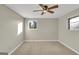 Sunny bedroom with two windows, neutral walls, and a modern ceiling fan at 6198 Rocky Creek Dr, Douglasville, GA 30135