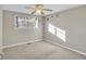 Comfortable bedroom with neutral carpet, ceiling fan, and sunlit window at 6198 Rocky Creek Dr, Douglasville, GA 30135