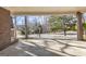 View from the carport to the street showcasing a lovely treed lot at 6198 Rocky Creek Dr, Douglasville, GA 30135