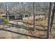 Brick home featuring attached carport, white railing, and a mature tree-lined lot at 6198 Rocky Creek Dr, Douglasville, GA 30135