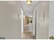 Inviting hallway with beige walls leading to a kitchen with blue countertops at 6198 Rocky Creek Dr, Douglasville, GA 30135