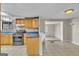 Kitchen boasting gas range, light wood cabinets, and access to the living room at 6198 Rocky Creek Dr, Douglasville, GA 30135