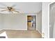 Living room showing neutral colored carpet, ceiling fan and view to kitchen at 6198 Rocky Creek Dr, Douglasville, GA 30135