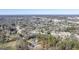 Expansive aerial view showcasing neighborhood and home's placement within mature trees at 5167 Martin St, Covington, GA 30014