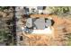 Aerial view showcases the home's layout, spacious driveway, and lush surrounding landscape at 5167 Martin St, Covington, GA 30014