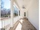 Spacious covered back porch with brick pavers, white railing and fan, perfect for enjoying the outdoors at 5167 Martin St, Covington, GA 30014