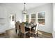 Cozy dining room with natural light, hardwood floors, and elegant chandelier at 5167 Martin St, Covington, GA 30014