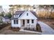 Charming home featuring a covered front porch, white siding, a well-manicured lawn, and a private driveway at 5167 Martin St, Covington, GA 30014