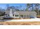 Stunning exterior view of home features a white facade, porch, and ample parking at 5167 Martin St, Covington, GA 30014