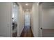 Hallway with wood floors leading to various rooms with carpet and tile at 5167 Martin St, Covington, GA 30014