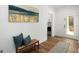 Inviting hallway with a bench, rug, wood floors, and mudroom access at 5167 Martin St, Covington, GA 30014