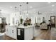 Gourmet kitchen featuring a large island, modern appliances, and open layout to the living area at 5167 Martin St, Covington, GA 30014