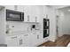 Well-equipped kitchen with white cabinets, stainless steel appliances, and modern fixtures at 5167 Martin St, Covington, GA 30014
