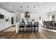 Open kitchen with white cabinets, an island with seating, and a dining area nearby at 5167 Martin St, Covington, GA 30014