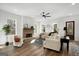Inviting living room featuring hardwood floors, a brick fireplace, and large windows at 5167 Martin St, Covington, GA 30014