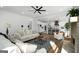 Spacious open-concept living room with hardwood floors, brick fireplace, and seamless flow to the kitchen at 5167 Martin St, Covington, GA 30014