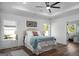 Serene bedroom with tray ceiling, hardwood floors, and natural light with an ensuite bathroom at 5167 Martin St, Covington, GA 30014