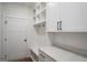 Bright mudroom area with white cabinets and granite countertop, a perfect spot for organization and storage at 5167 Martin St, Covington, GA 30014