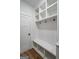 A pristine mudroom with built-in bench, cubbies, and coat hooks offers organized entryway storage at 5167 Martin St, Covington, GA 30014