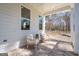 Relaxing porch with wicker seating, brick flooring, and a view of the surrounding nature at 5167 Martin St, Covington, GA 30014