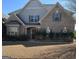 Charming brick home with a symmetrical facade, a manicured lawn, and a welcoming entryway at 1186 Diamond Xing, Mcdonough, GA 30252