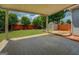 Covered patio overlooks private backyard with wood fence and mature trees at 1186 Diamond Xing, Mcdonough, GA 30252
