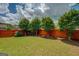Lush backyard featuring a manicured lawn, a wooden fence, and mature trees at 1186 Diamond Xing, Mcdonough, GA 30252