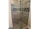 Bathroom showcasing a glass-enclosed shower with stone accent tiles and chrome fixtures at 1186 Diamond Xing, Mcdonough, GA 30252