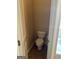 Cozy powder room featuring a white toilet, tile floors, and neutral paint at 1186 Diamond Xing, Mcdonough, GA 30252