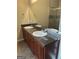 Bathroom with double sinks, dark wood cabinets, granite countertops, and tile floors at 1186 Diamond Xing, Mcdonough, GA 30252