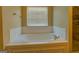 Elegant bathroom featuring a soaking tub with tiled surround and a walk-in shower at 1186 Diamond Xing, Mcdonough, GA 30252