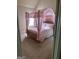 Pretty bedroom with a charming pink canopy bed and sunlight streaming through the window at 1186 Diamond Xing, Mcdonough, GA 30252