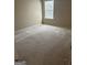 Spacious bedroom with neutral carpeting and a window allowing natural light at 1186 Diamond Xing, Mcdonough, GA 30252
