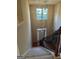 View from the staircase of the two-story entryway with hardwood floors and a beautiful decorative light fixture at 1186 Diamond Xing, Mcdonough, GA 30252
