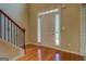 Inviting entryway showcasing gleaming hardwood floors and a staircase with a wooden banister at 1186 Diamond Xing, Mcdonough, GA 30252