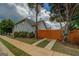 Side view of a two-story home with a wooden fence and mature trees at 1186 Diamond Xing, Mcdonough, GA 30252