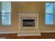 Cozy fireplace featuring a marble hearth, decorative mantel, and natural light from bright windows at 1186 Diamond Xing, Mcdonough, GA 30252