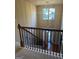 Bright foyer with a decorative chandelier, tile floors, and decorative wood railing at 1186 Diamond Xing, Mcdonough, GA 30252