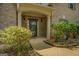 Charming front entrance with a brick facade, arched porch, and manicured shrubs at 1186 Diamond Xing, Mcdonough, GA 30252