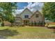 Charming two-story brick home featuring lush landscaping and a well-manicured lawn at 1186 Diamond Xing, Mcdonough, GA 30252
