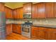 Stylish kitchen with stainless steel appliances, wooden cabinets, and hardwood floors at 1186 Diamond Xing, Mcdonough, GA 30252