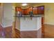 Open-concept kitchen with dark wood cabinets, stainless steel appliances, and peninsula for seating at 1186 Diamond Xing, Mcdonough, GA 30252