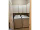 Functional laundry room with updated appliances and ample cabinet storage at 1186 Diamond Xing, Mcdonough, GA 30252