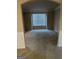Cozy living room with neutral carpet, large window with blind, and traditional wainscoting details at 1186 Diamond Xing, Mcdonough, GA 30252