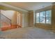 Open-concept living room showcasing staircase, large windows, and a neutral color palette at 1186 Diamond Xing, Mcdonough, GA 30252